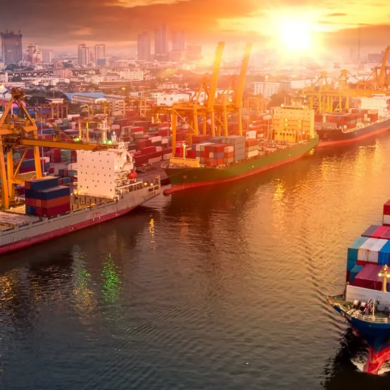 Logistics-and-transportation-of-Container-Cargo-ship-and-Cargo-plane-with-working-crane-bridge-in-shipyard-at-sunset-logistic-import-export-and-transport-industr